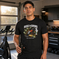 J&G Workwear black cotton crew neck t-shirt with Rise and Grind graphic print worn by a man in a home gym setting.